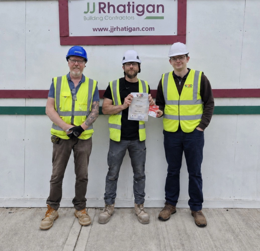 Zukasz receives his award from Sean (left) and Shane at the Cork site