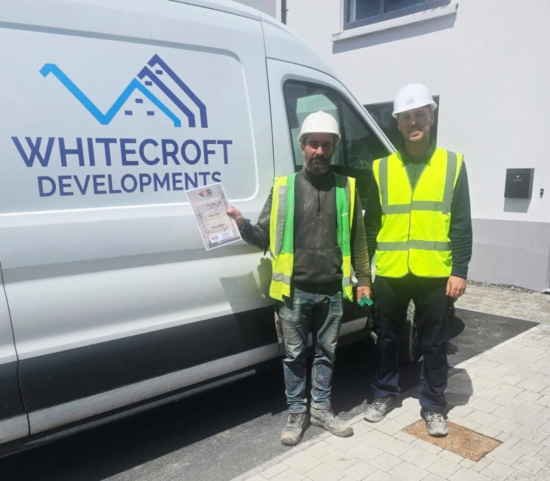 Felix displays his award alongside site manager Cathal