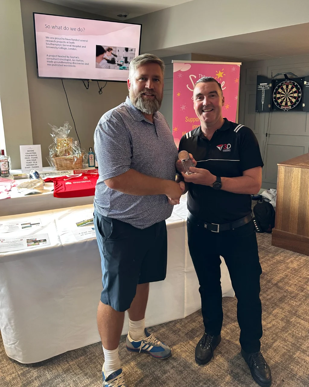 Barry from Wates collects the Nearest the Pin trophy on behalf of Tom Hooper-Smith
