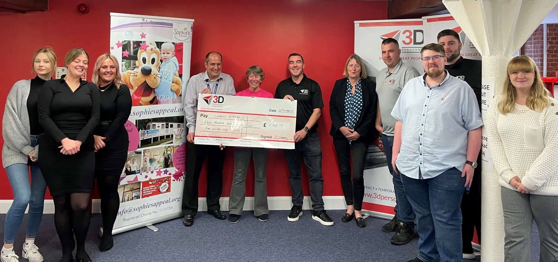 3D Personnel, Managing Director, Damian Doherty, presents a cheque for £11,705 to Lin and Mike Barringer after the 2022 event, while the Southampton office staff look on 