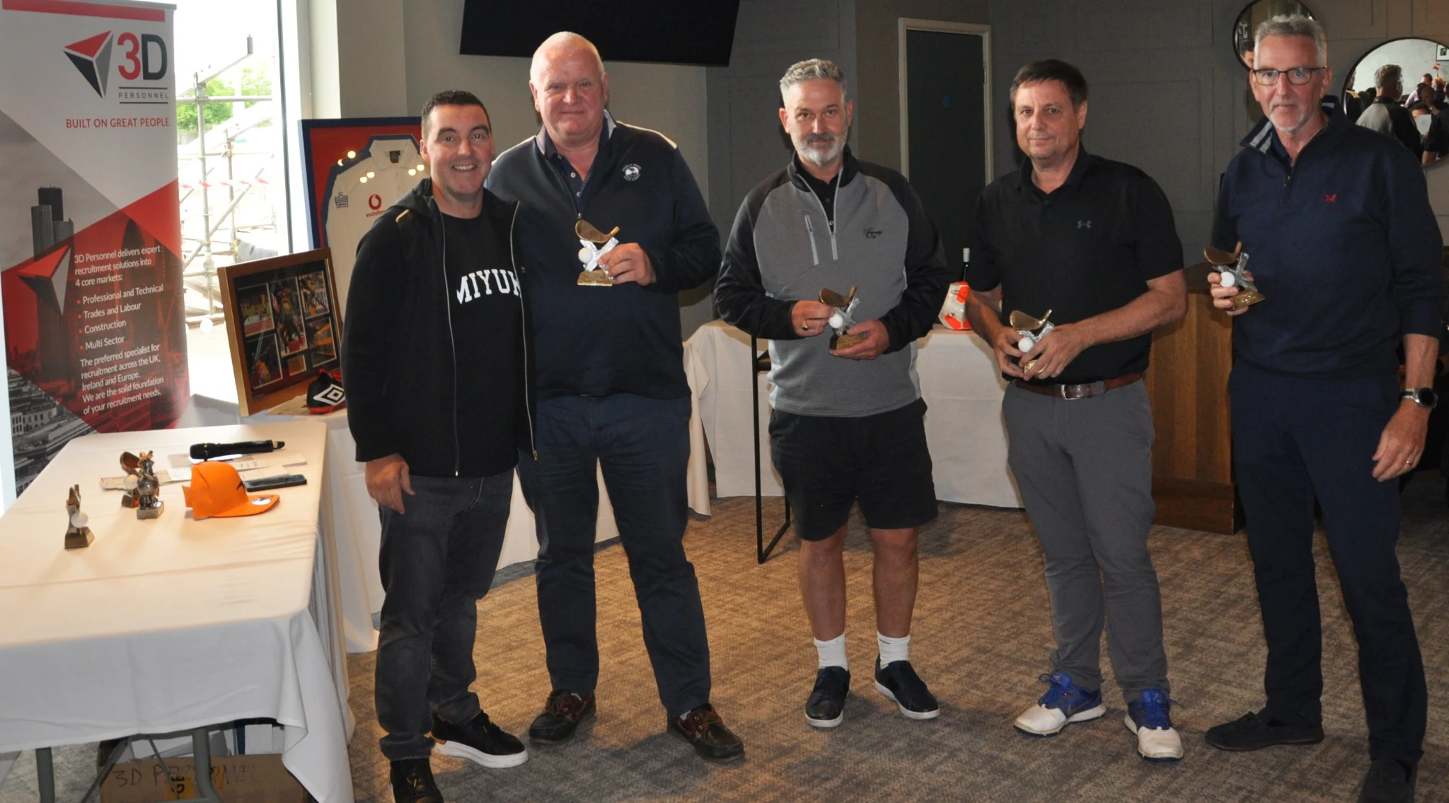 Damian Doherty makes a presentation to Nick and Rob from Bellway Homes, and their 2022 winning team