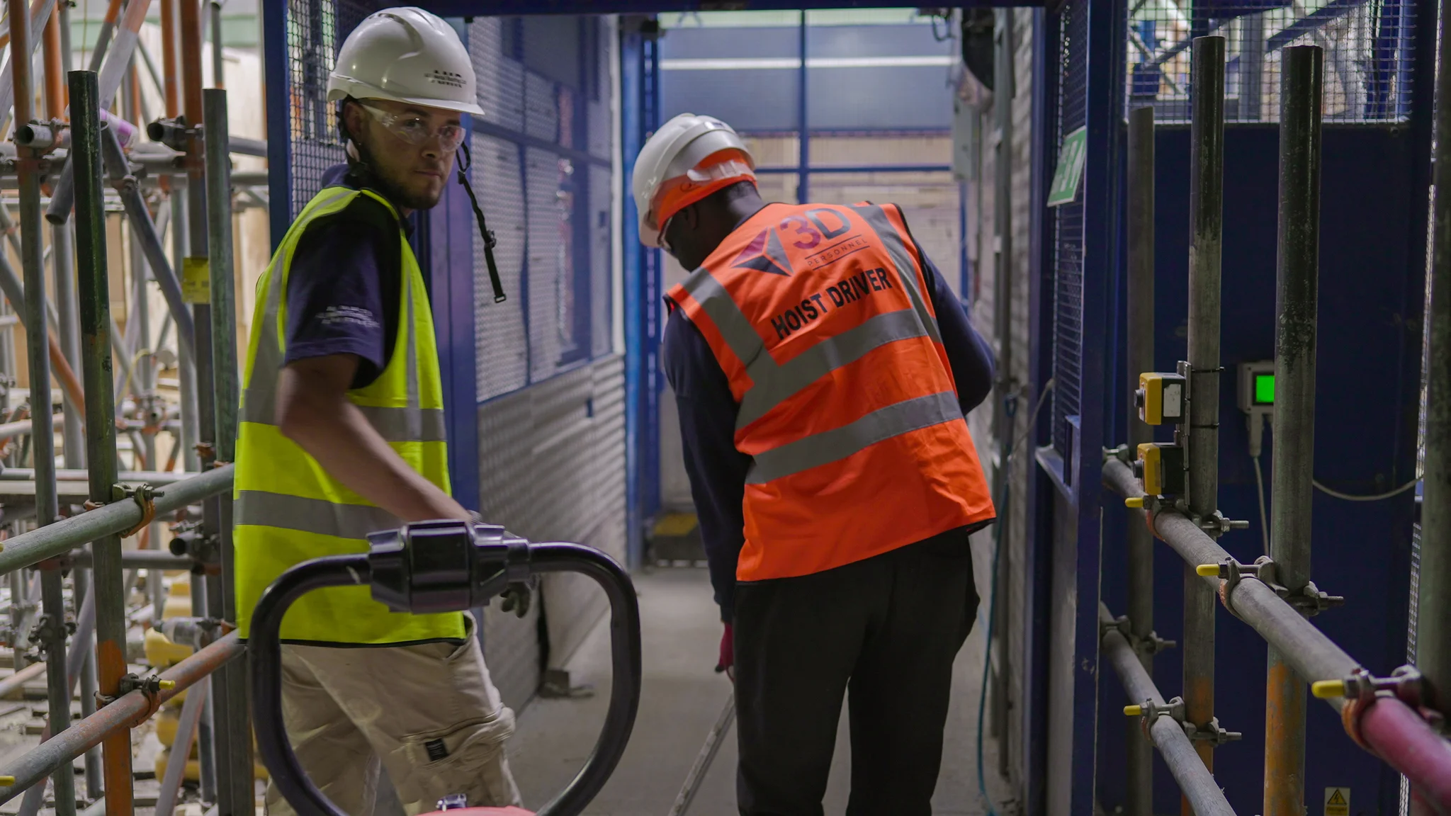A hoist driver and operative on a construction site
