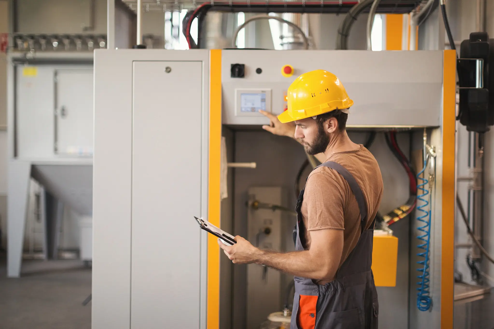 A technician inspecting industrial equipment