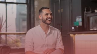 Recruitment consultant smiling to the right. There is a pink overlay on top