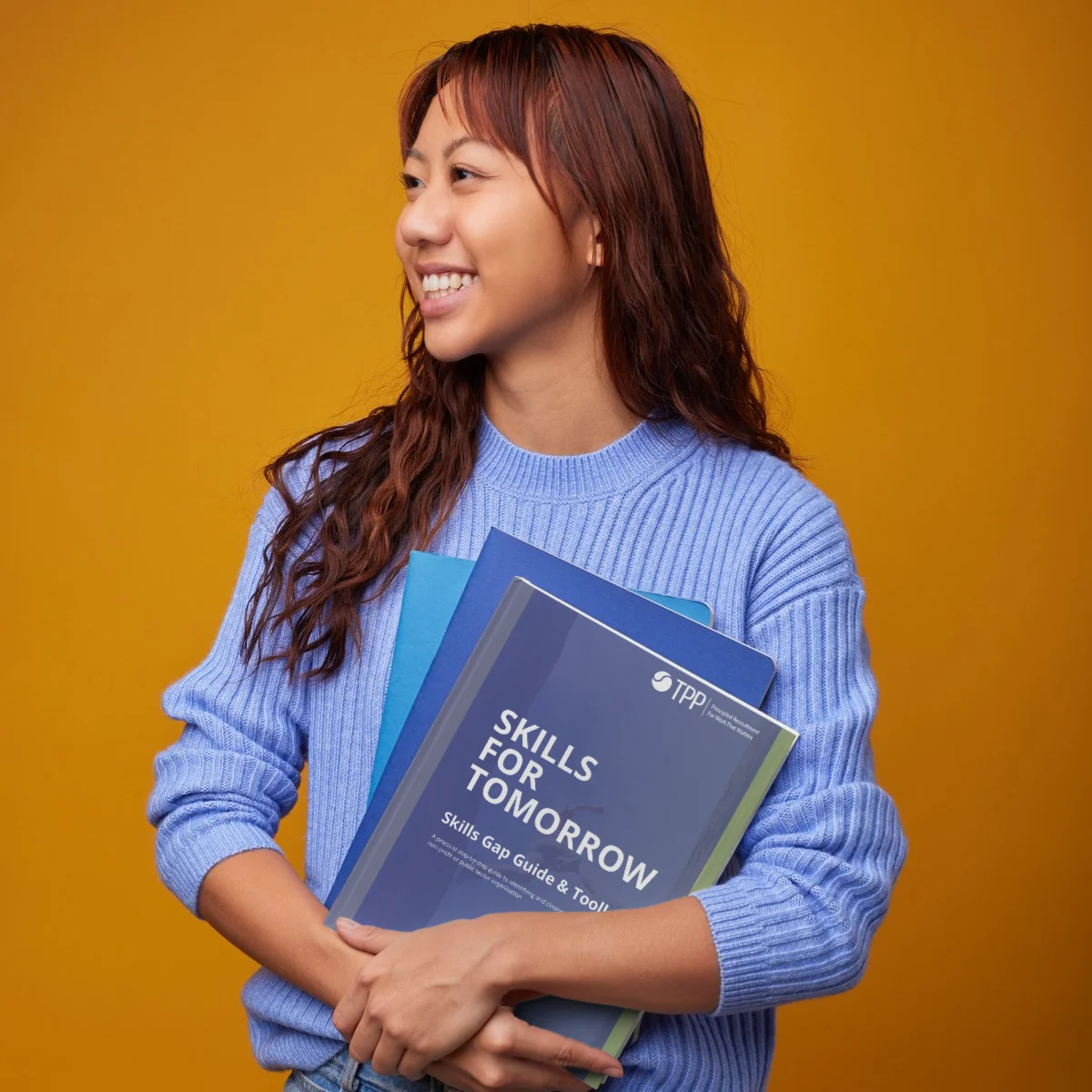 Woman holding TPP's Skills Gap Guide & Toolkit