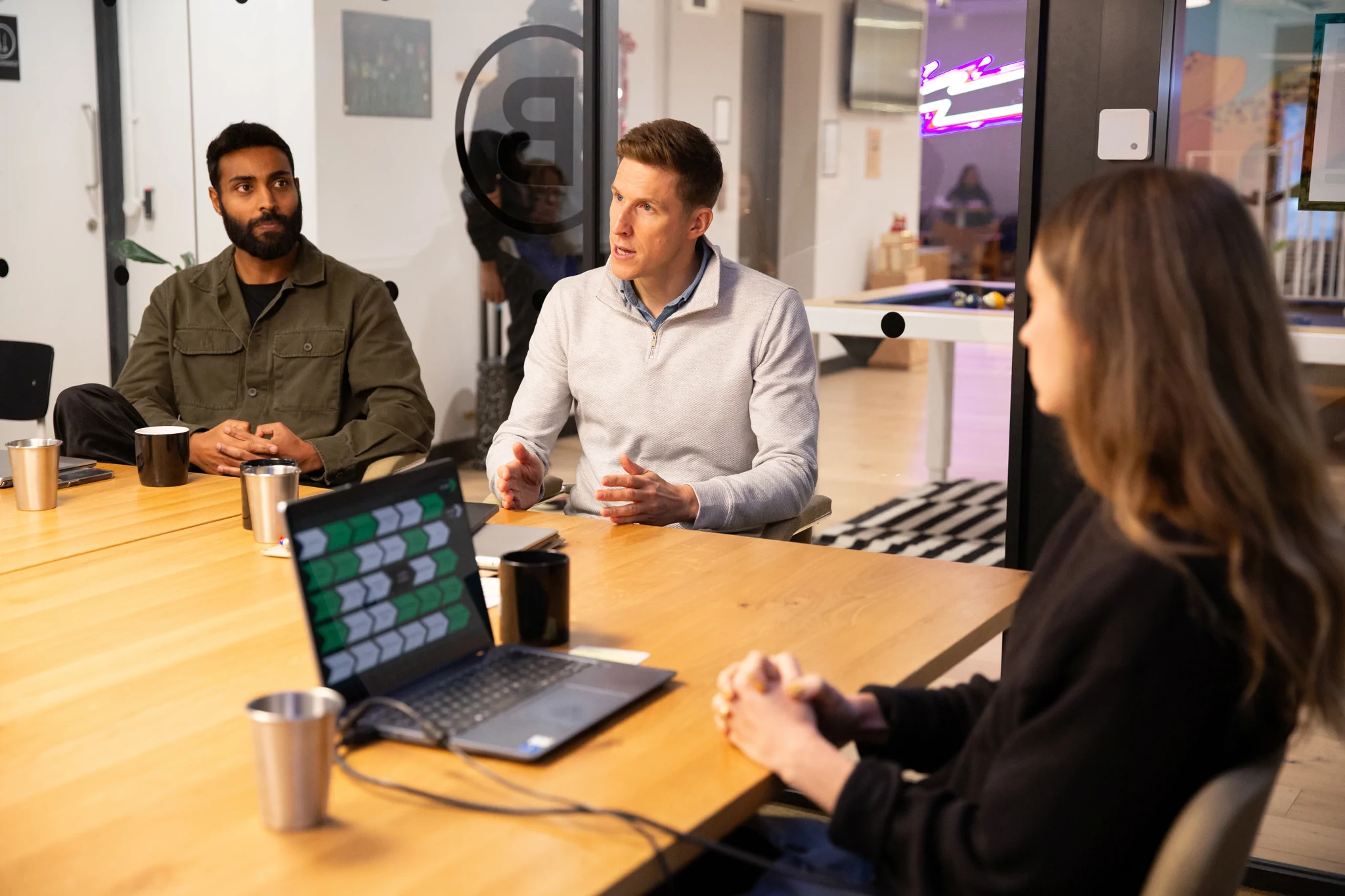 One leader talks whilst two colleagues are listening in a boardroom
