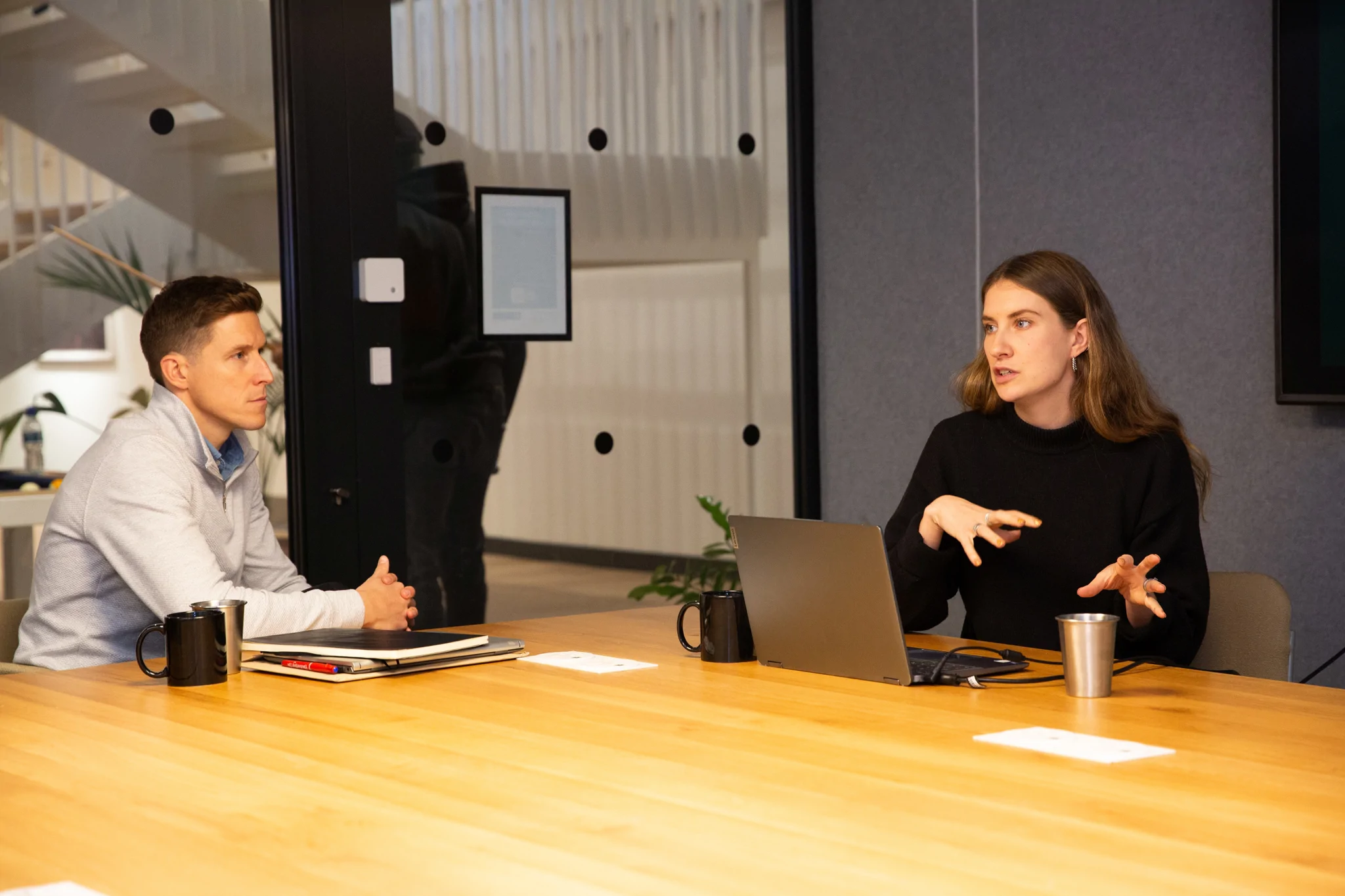 Two people sat at desk conducting an interview