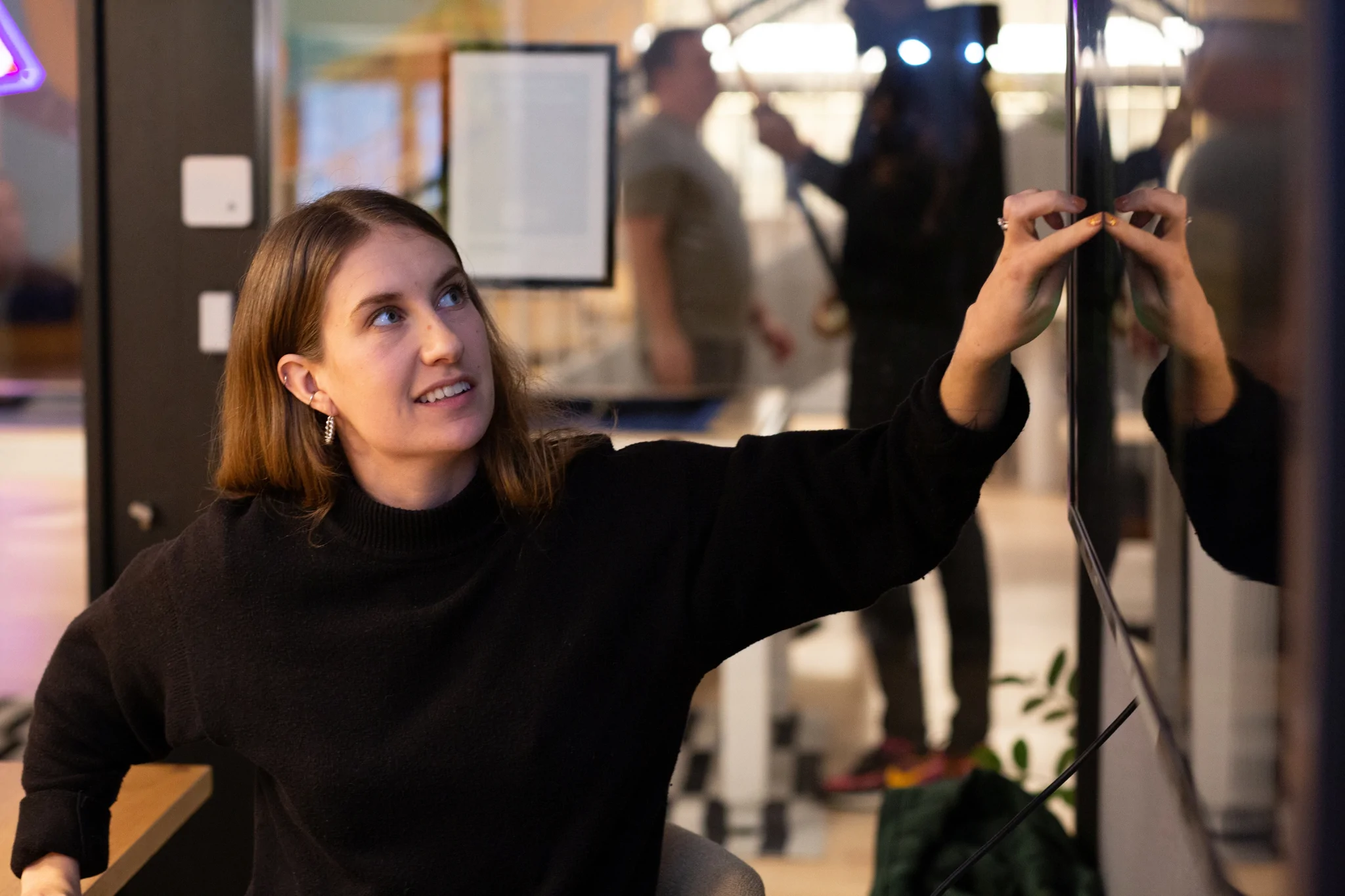 Woman pointing at a screen
