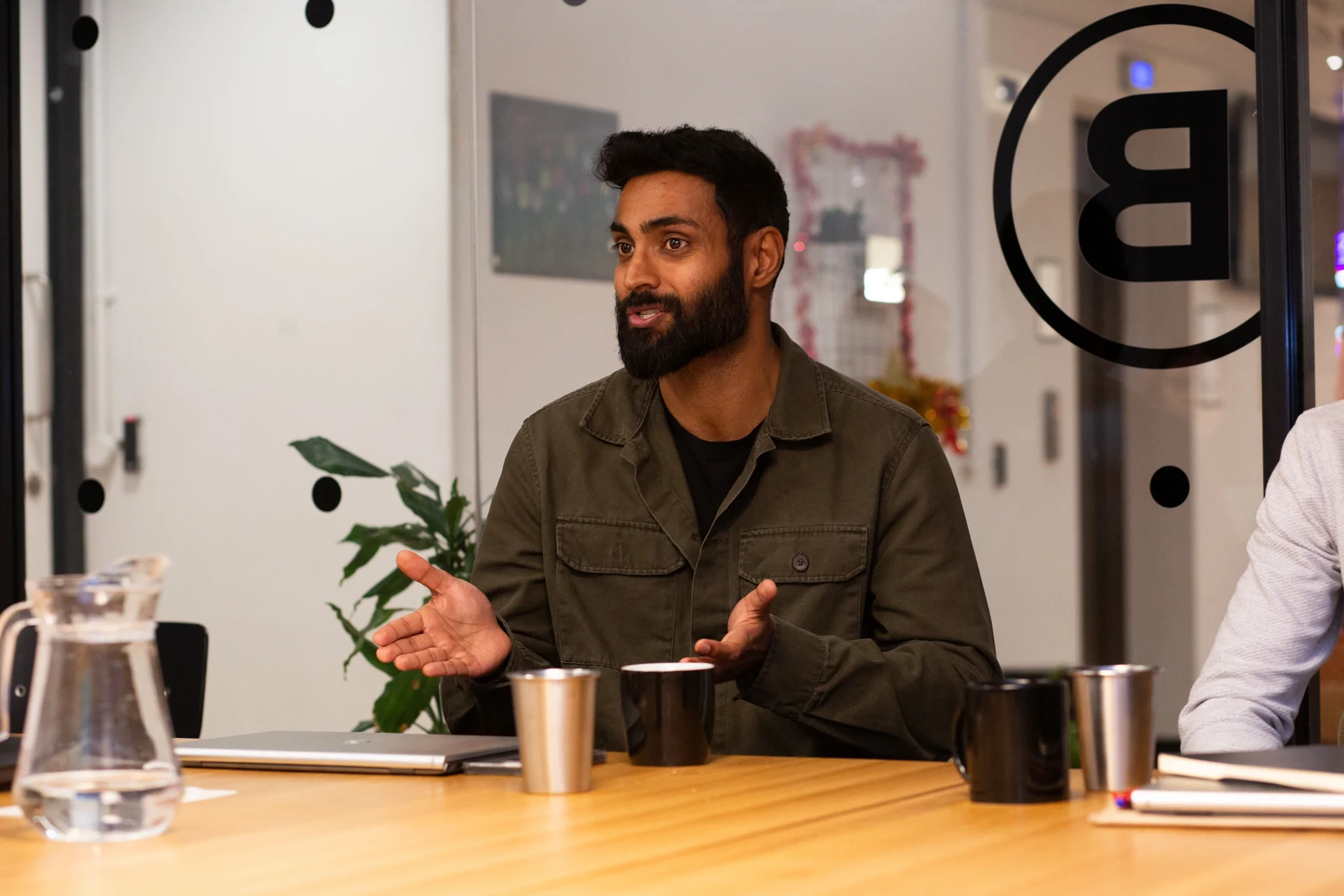 Man explaining whilst sat a table