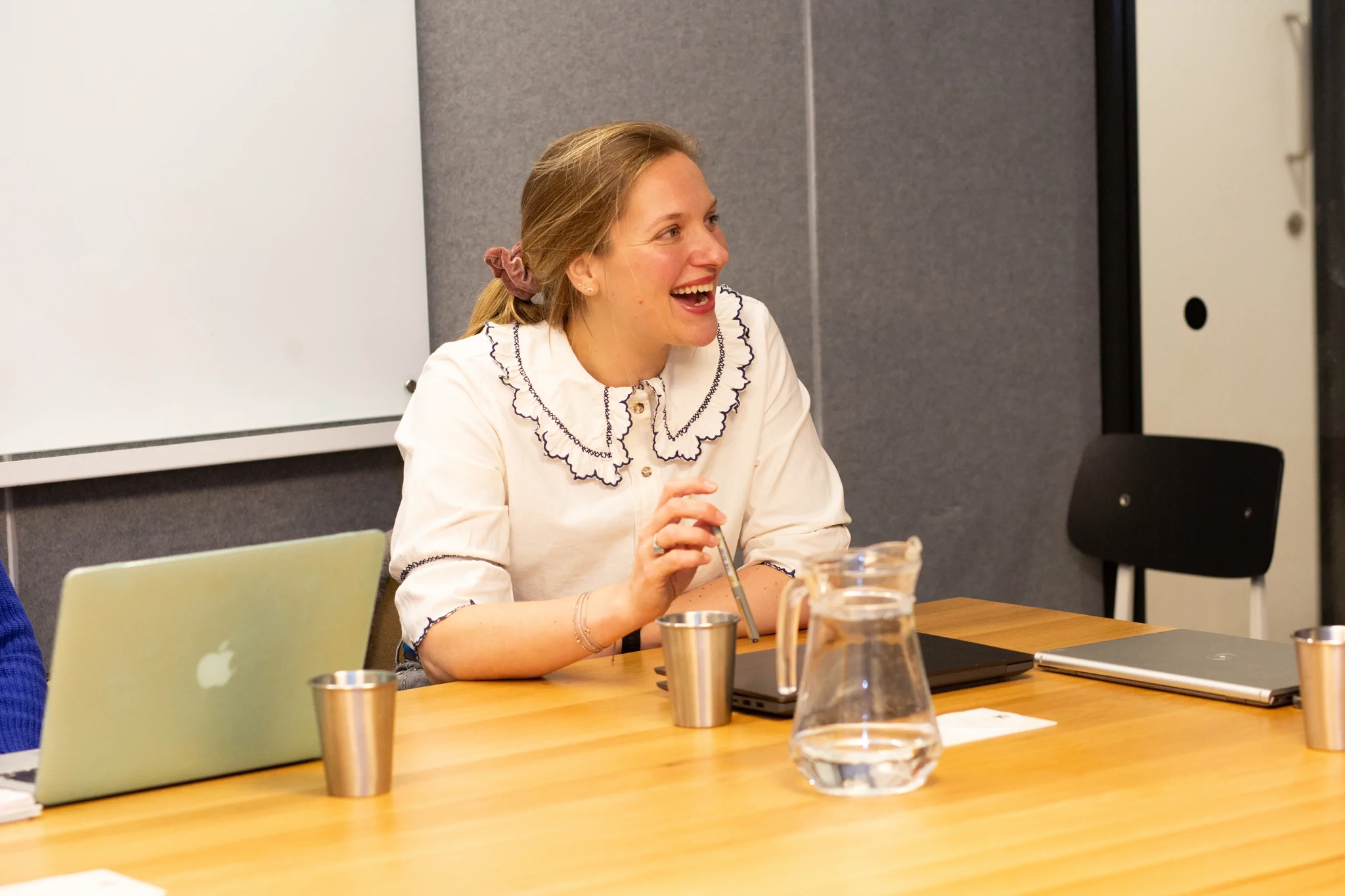 Lady laughing in meeting room