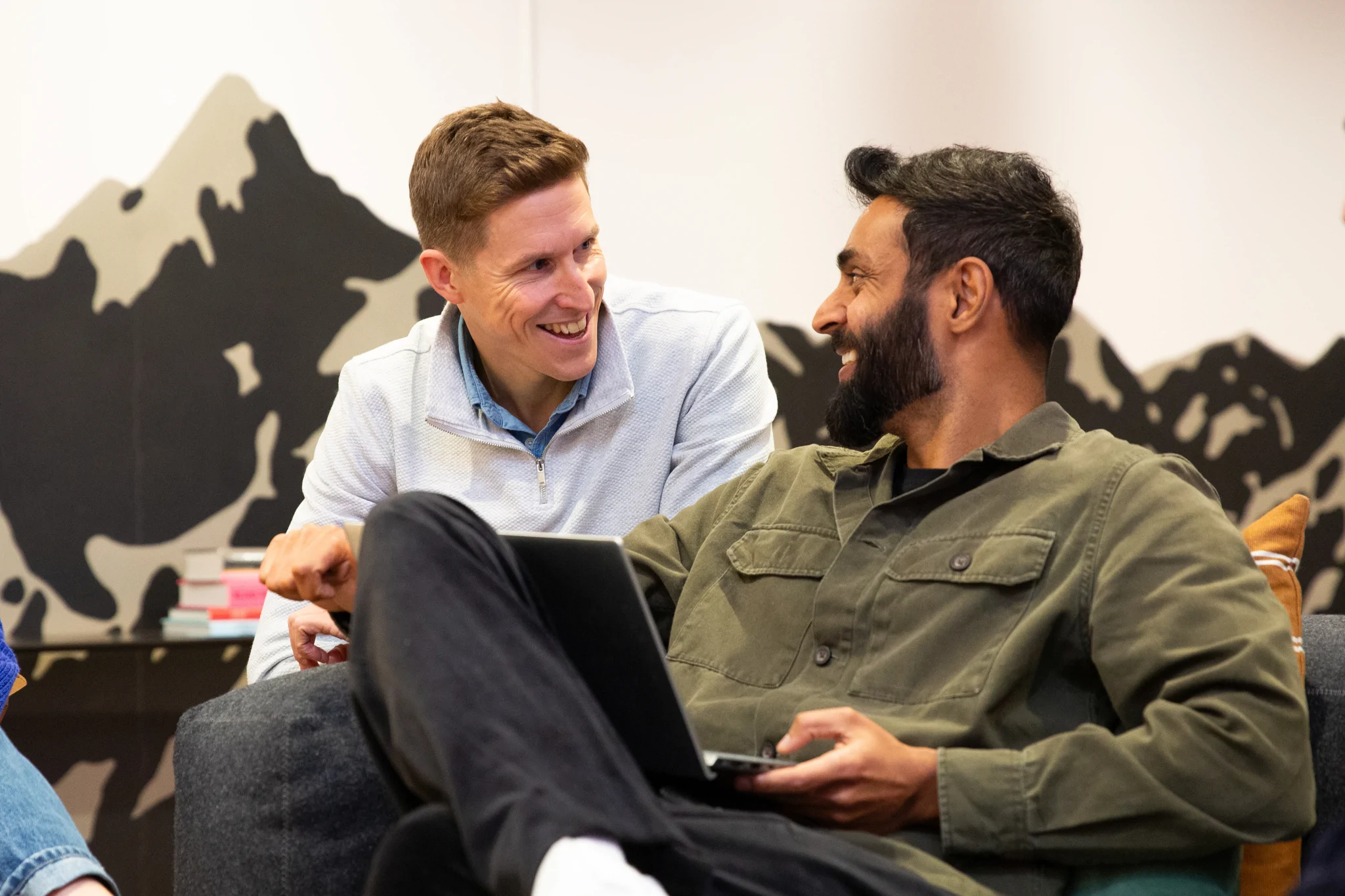 Two men smiling at each other