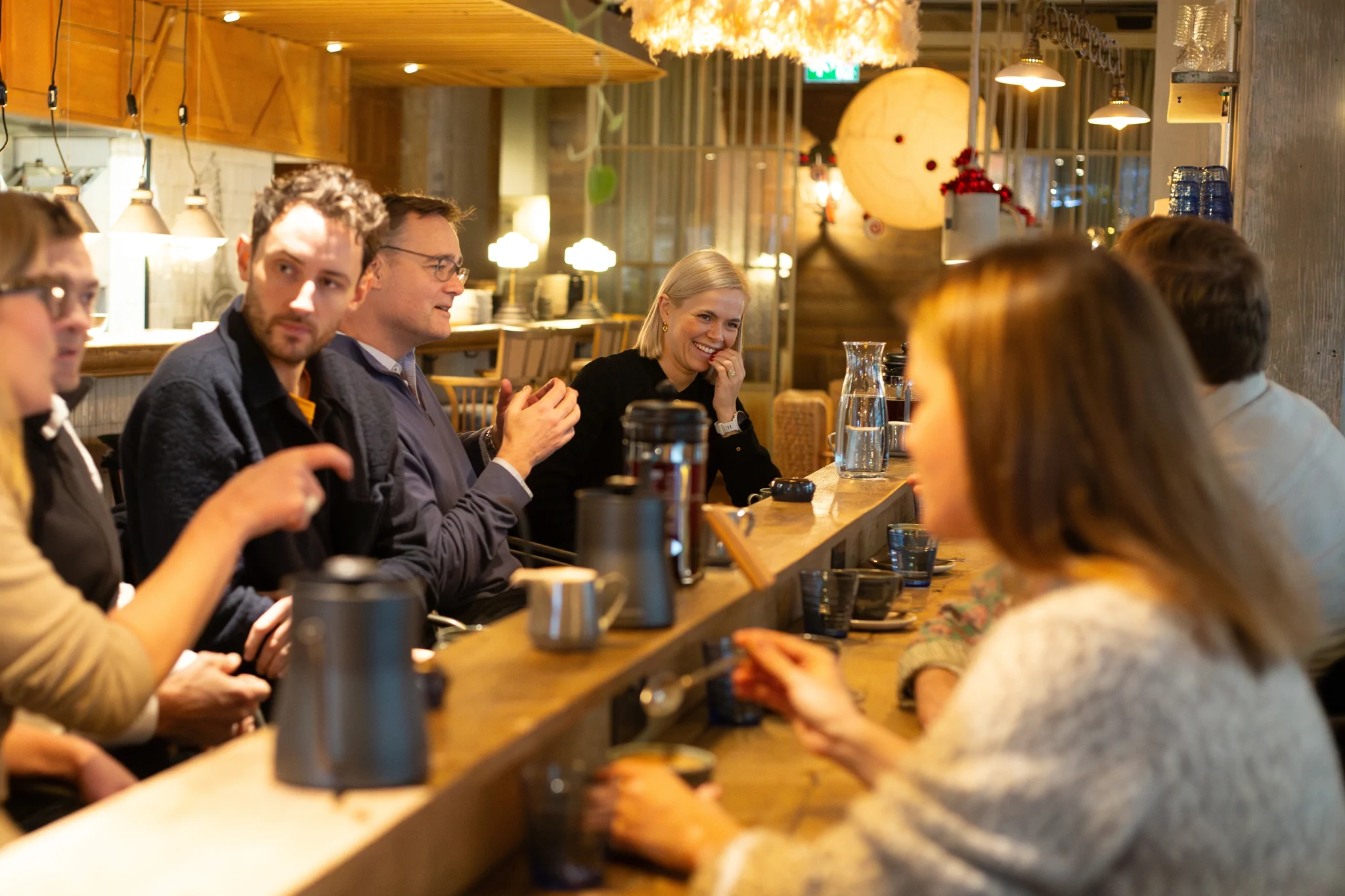 Group of CFOs chatting over coffee