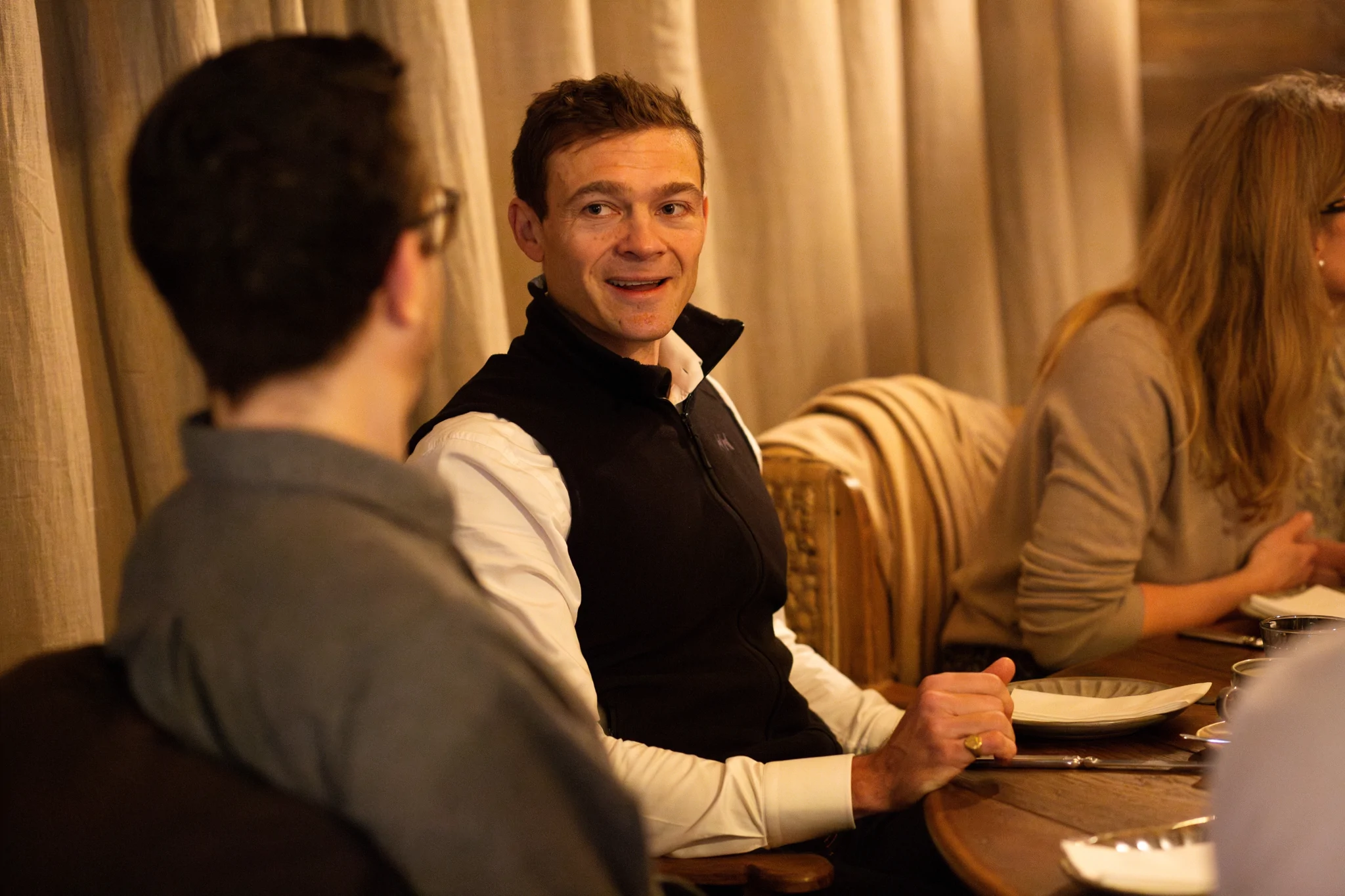 Two men chatting at a roundtable event