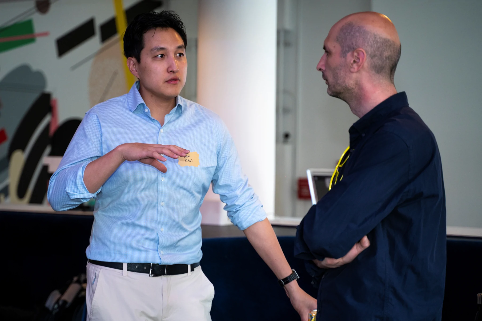 Two men standing and talking