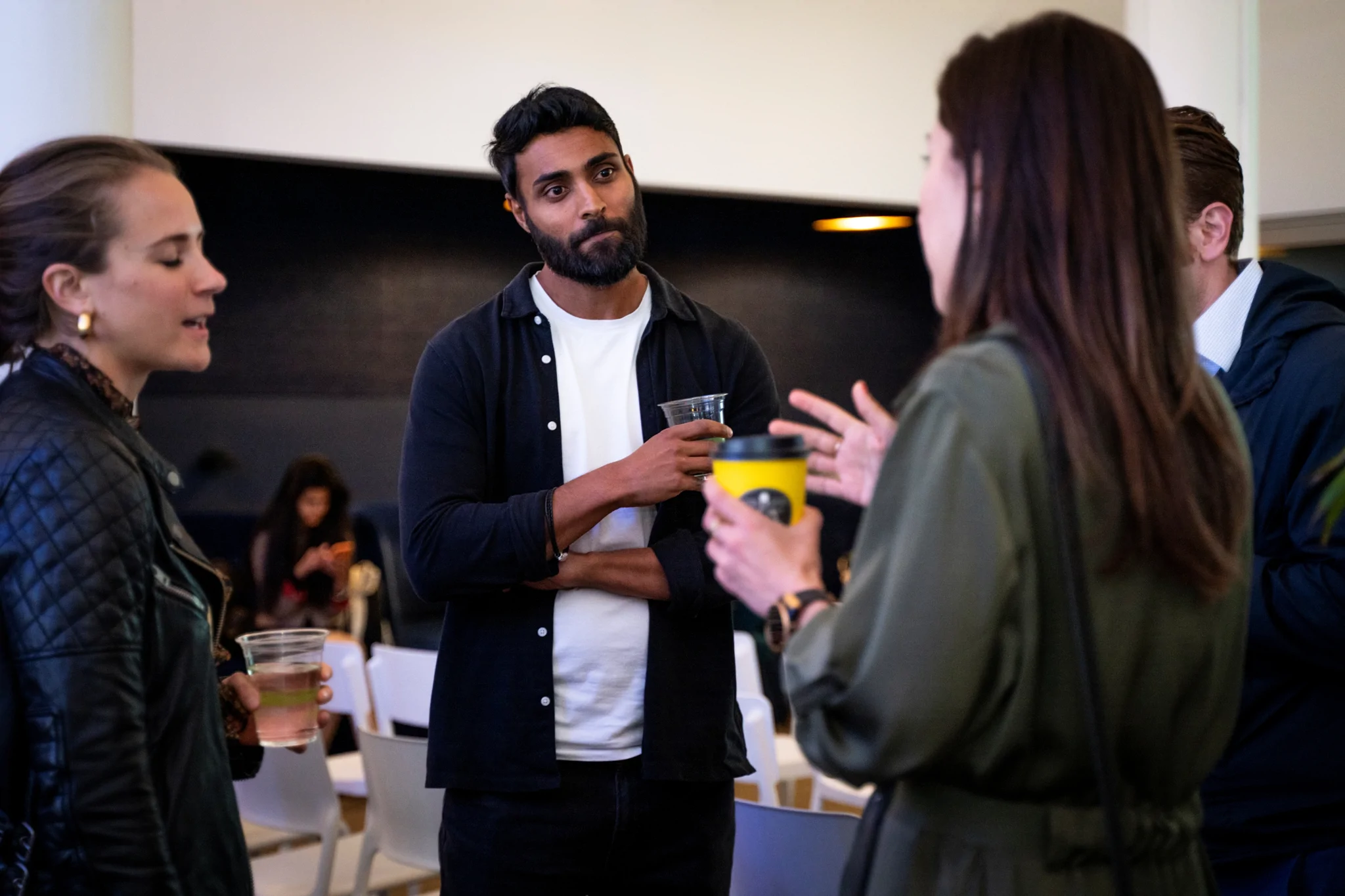 Four people deep in conversation at a networking event