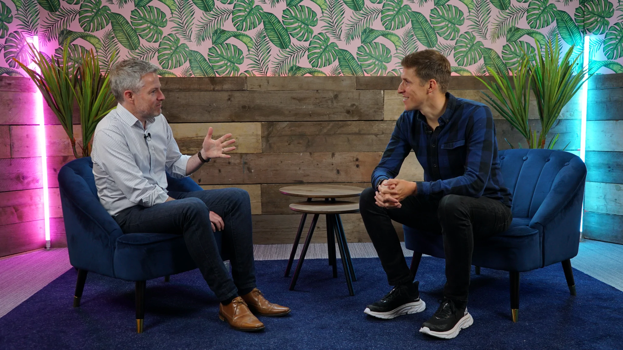 Two men chatting at a podcast recording