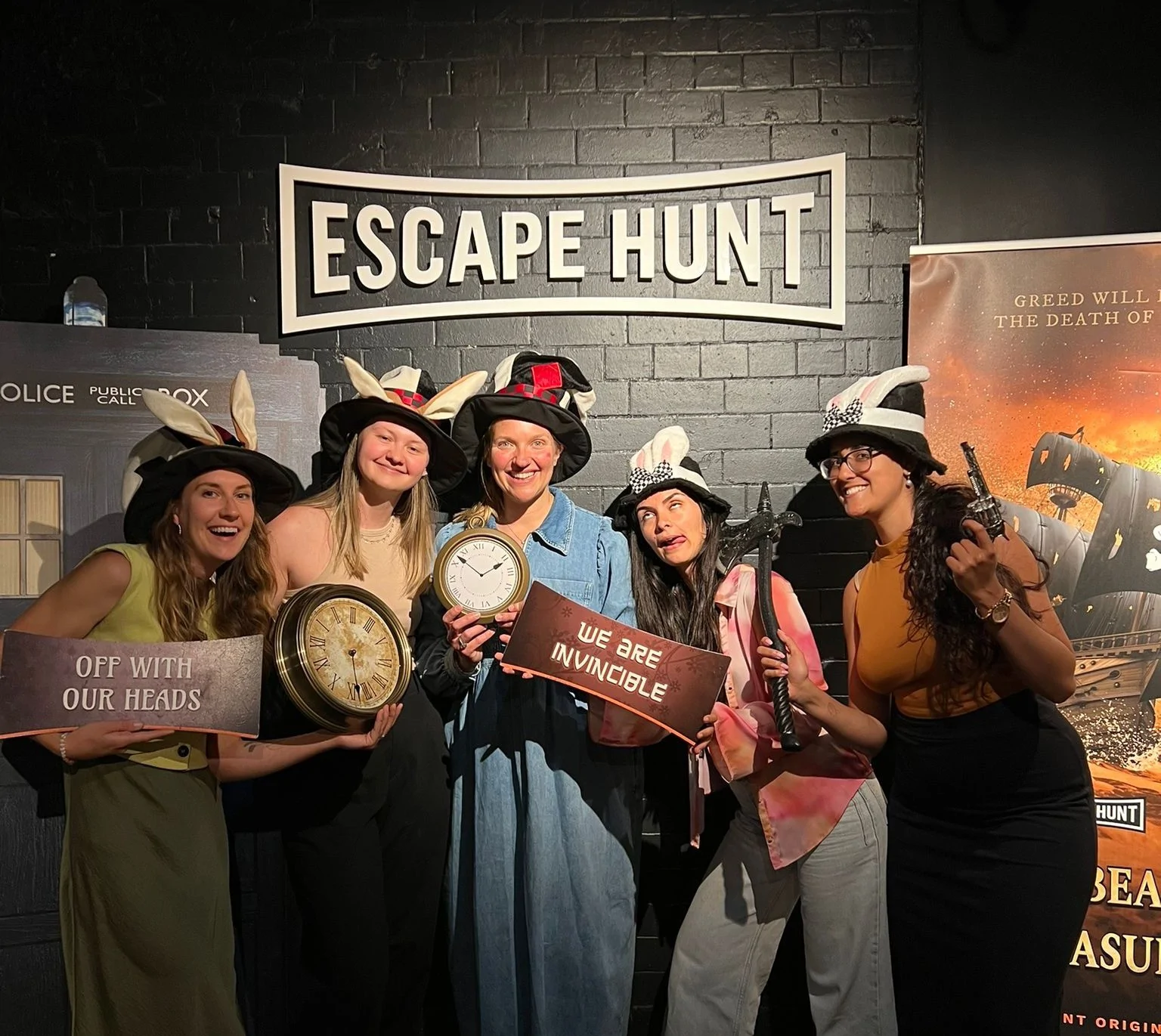 Five women wearing silly costumes posing